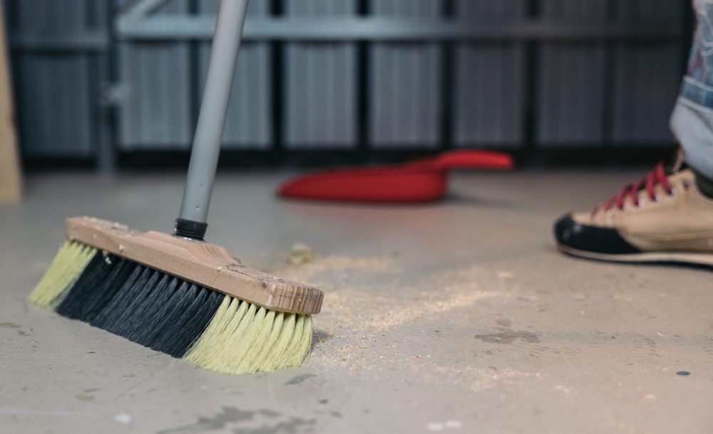cleaning-sawdust-from-the-floor-with-a-broom-clea-2025-01-10-06-47-48-utc
